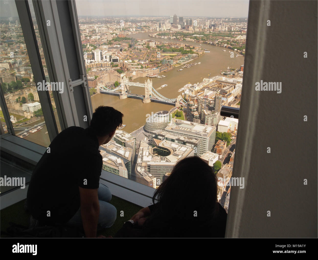 A la vista de la gente en el piso de visualización superior, 72, de la Shard, Londres, mirando a través de la capital de Gran Bretaña Foto de stock