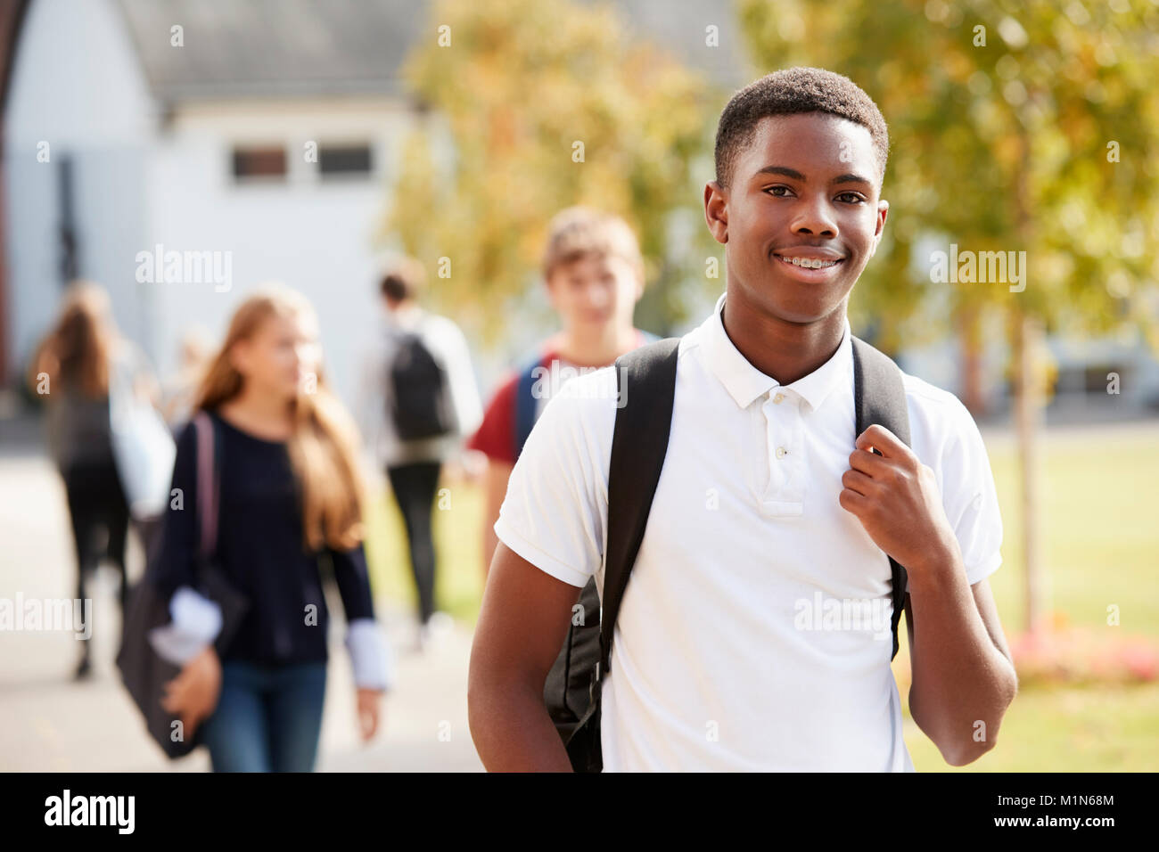 Retrato de adolescente masculino estudiante caminando alrededor del Campus Universitario Foto de stock