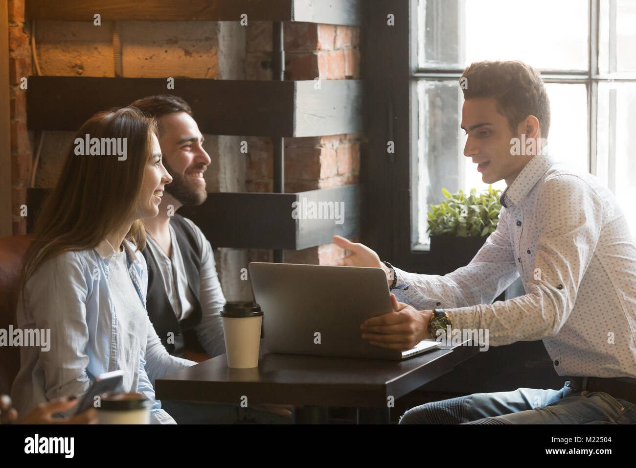Corredor de seguros o vendedor haciendo ofrecer a la pareja en el café Foto de stock