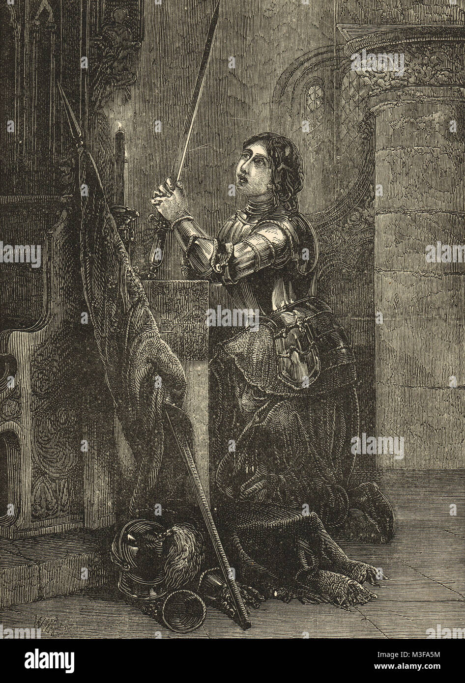 Juana de Arco en la armadura se arrodilló en oración Foto de stock