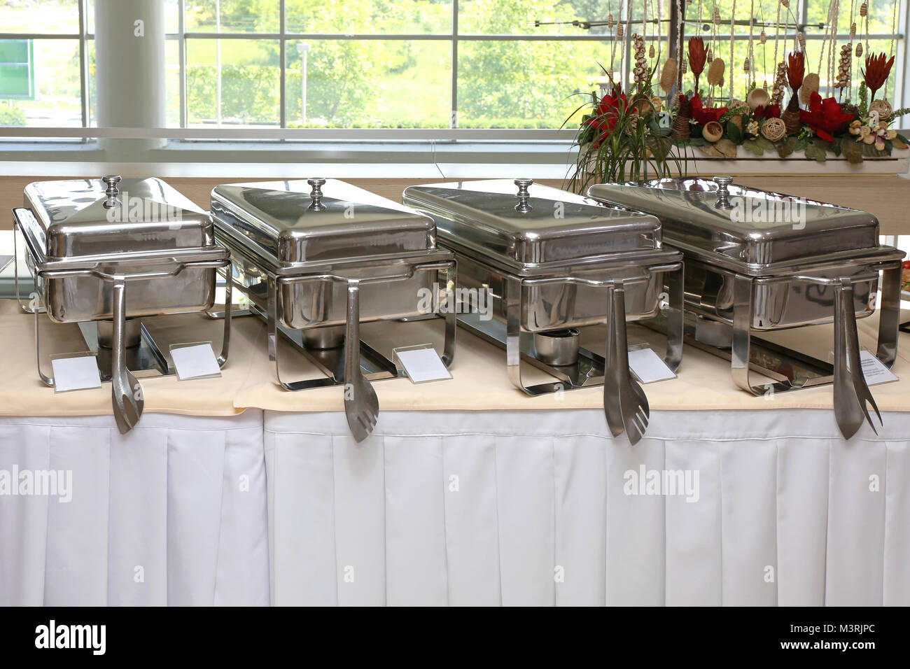 Mesa de buffet con acero inoxidable para calentar alimentos Fotografía de  stock - Alamy
