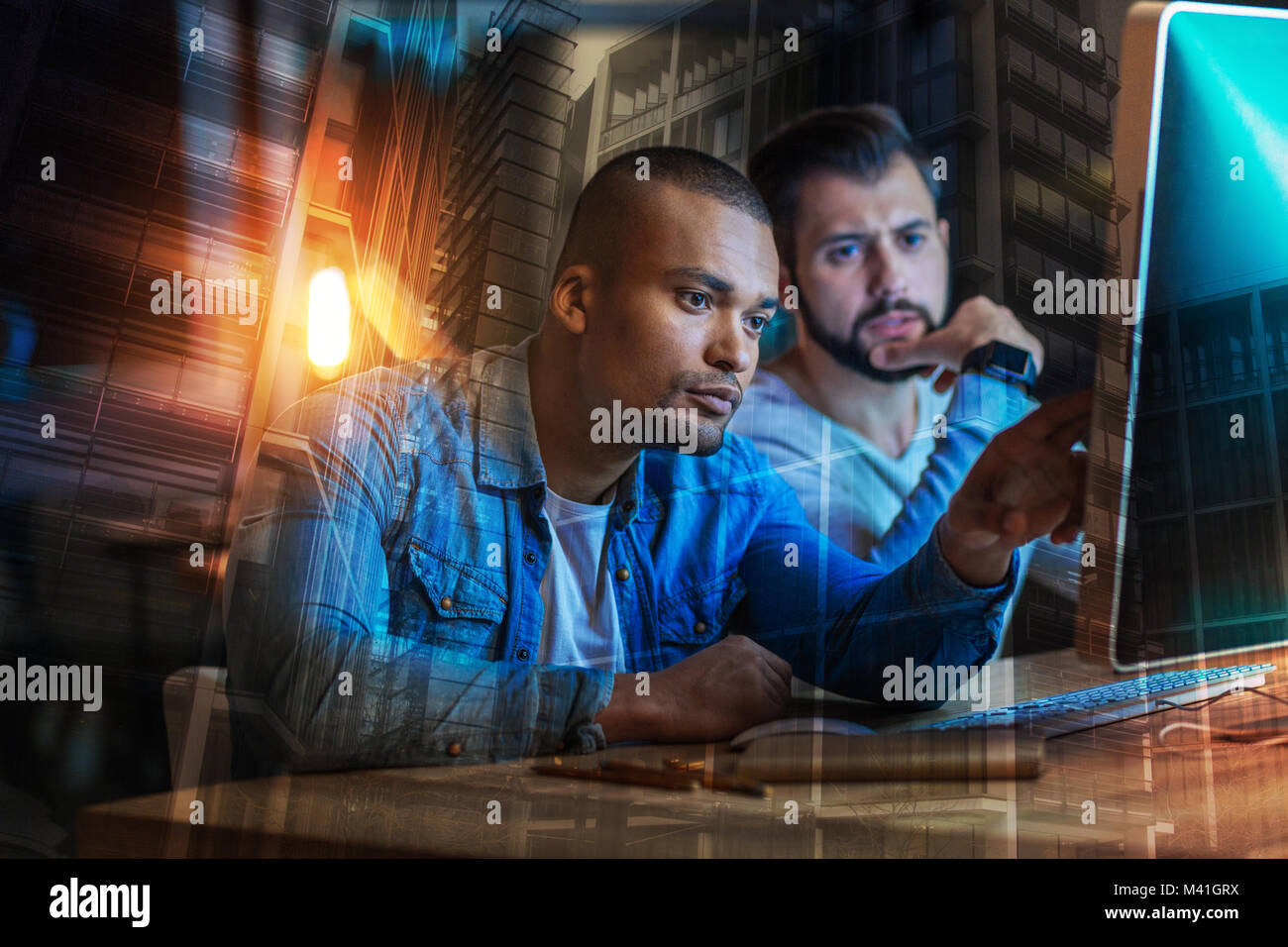 Los hombres sentimiento concentrado preocupado mientras mira la pantalla de su ordenador Foto de stock