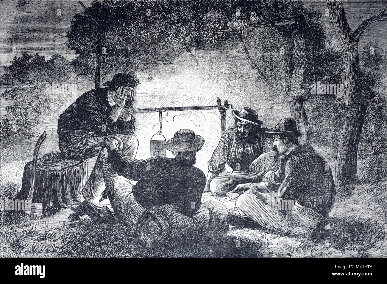 Los primeros colonos o los colonizadores europeos alrededor de una fogata en Queensland, Australia (1879) grabado Foto de stock