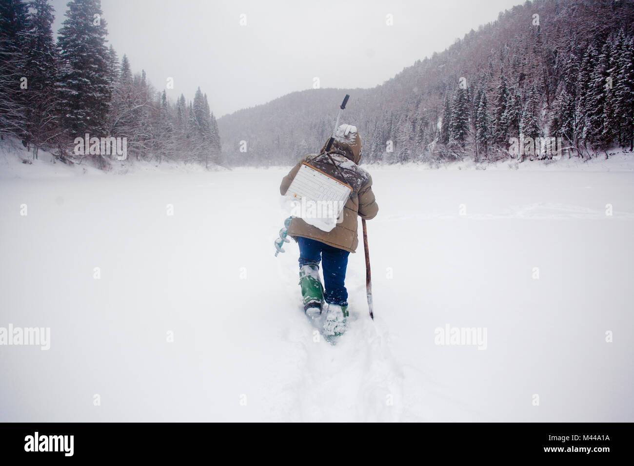 Hombre caminando en nieve paisaje, Ural, Sverdlovsk, Rusia Foto de stock