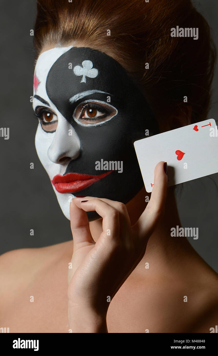 Chica en imagen de joker con tarjetas en Studio disparar Foto de stock