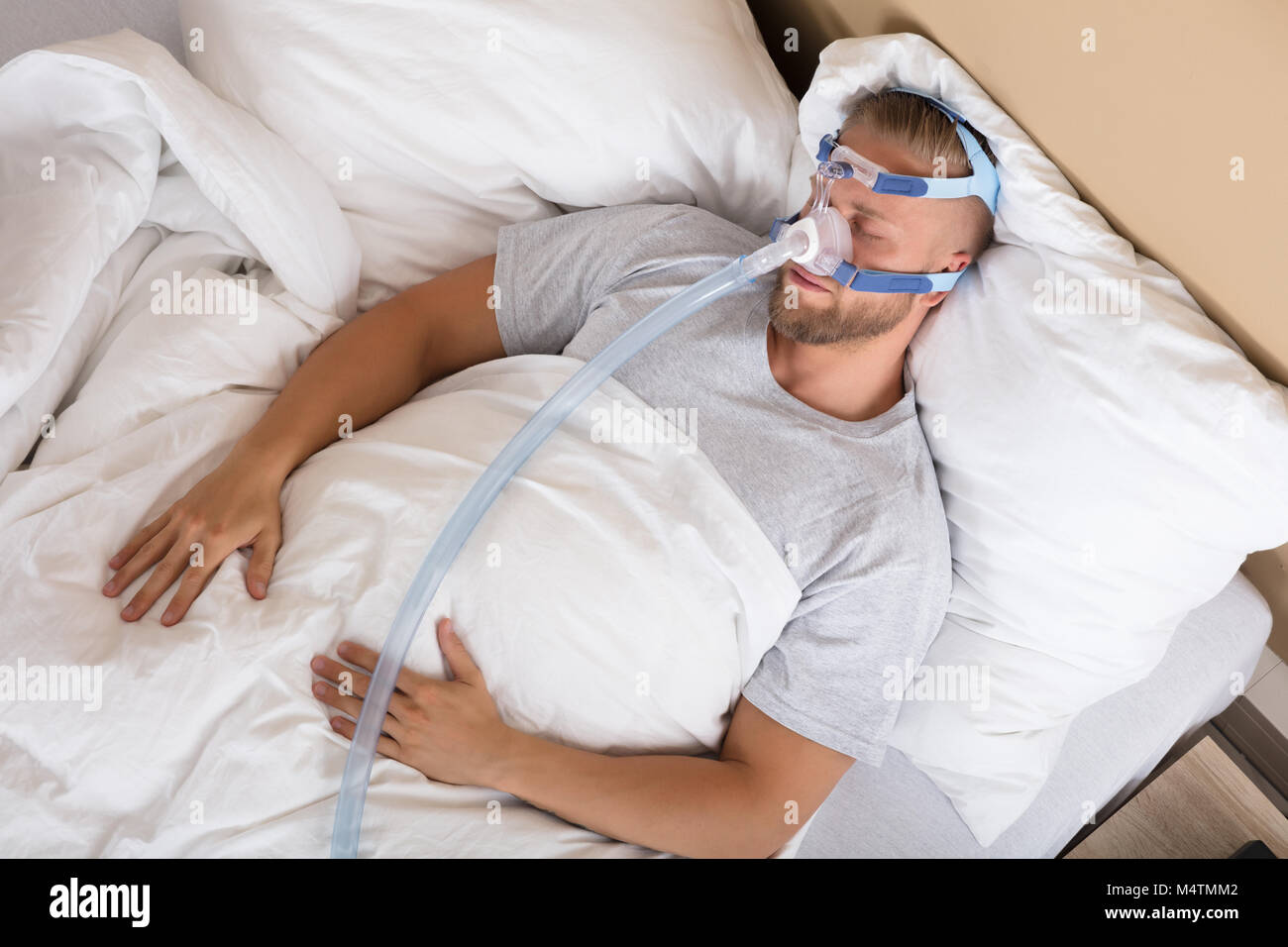 Hombre asiático con apnea del sueño usando la máquina cpap
