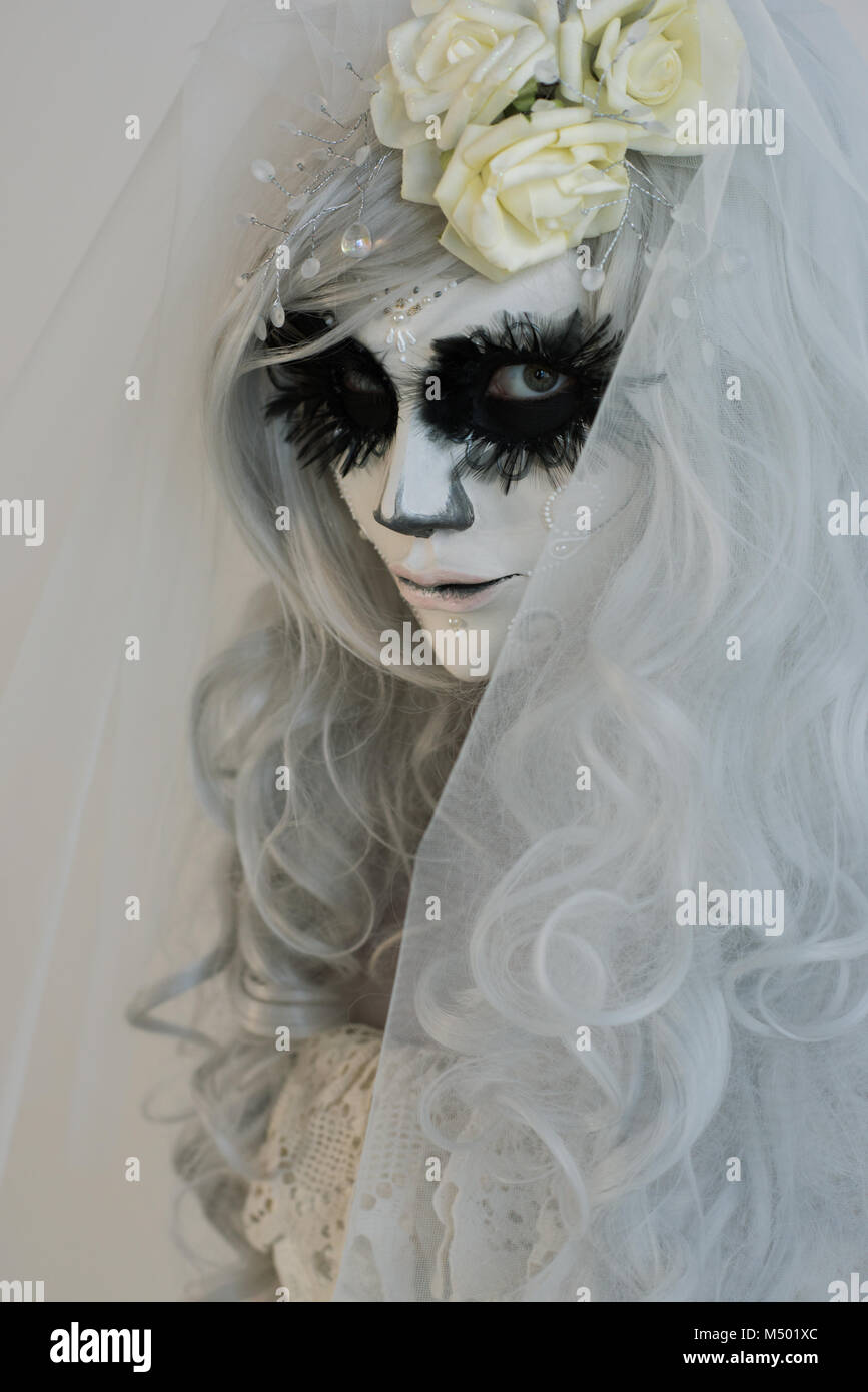 Bruja de Halloween. Hermosa mujer vistiendo santa muerte máscara y vestido  de novia Fotografía de stock - Alamy