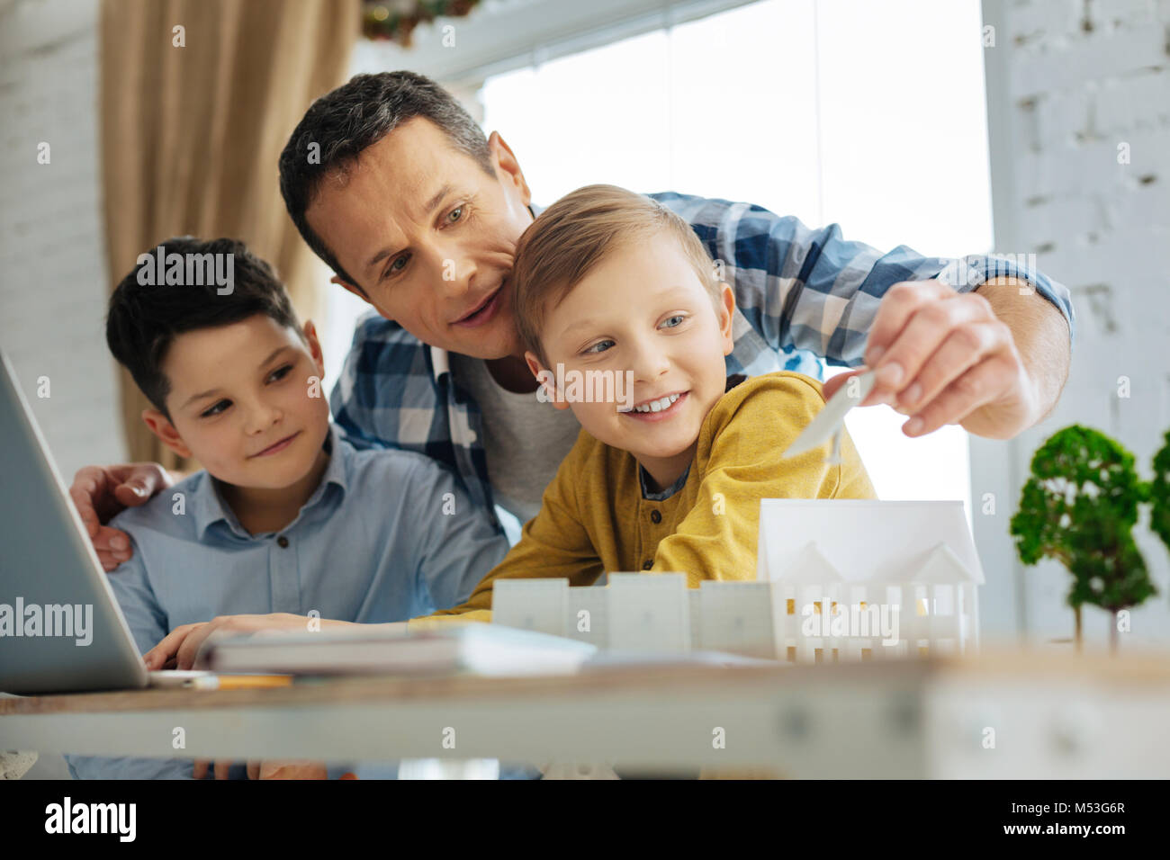 Padre bondadoso dando a sus hijos consejos acerca de sus proyectos de