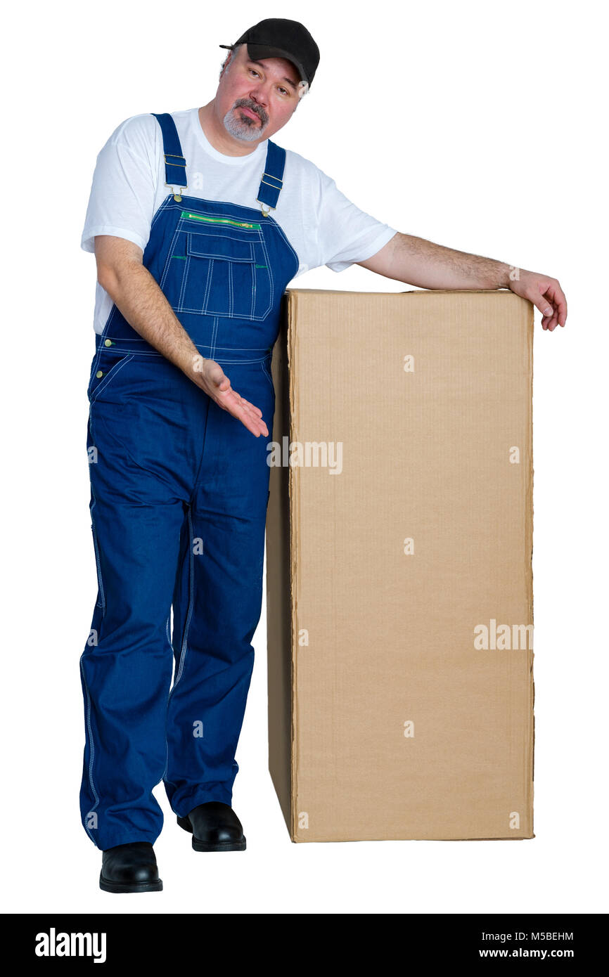 Trabajador de almacén gesticulando con su mano en una caja grande con una expresión quizzical preguntando si este es el correcto aislado en blanco Foto de stock