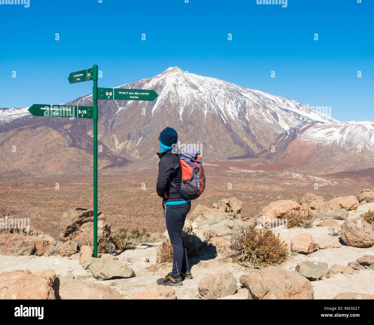 Excursionista hembra con fantástica vista del Teide cubierto de nieve desde la Degollada de Guajara caminando en Nacional del Teide en Tenerife, Islas Canarias, España Foto de stock