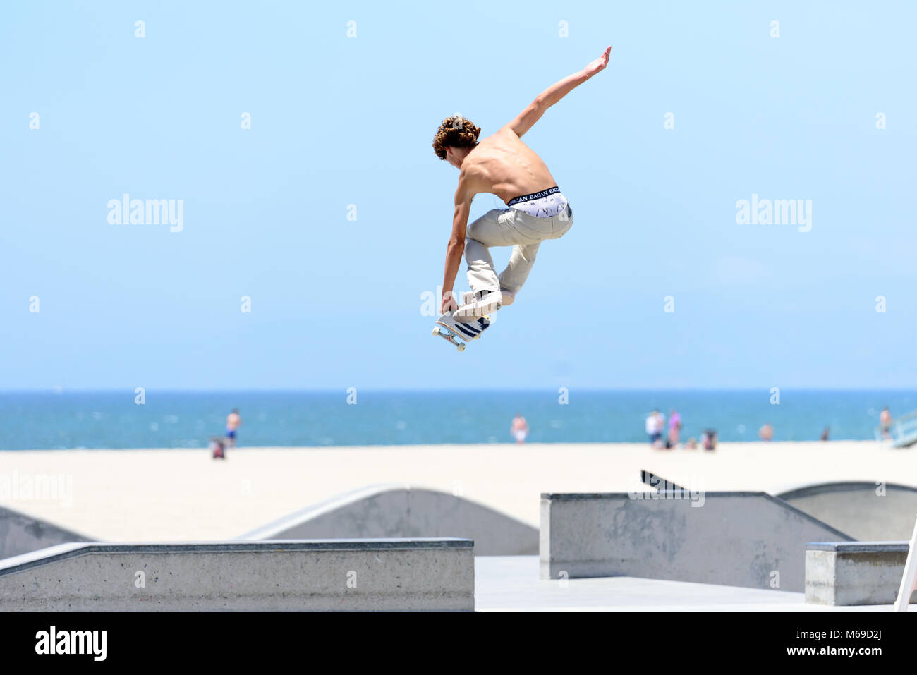 Joven skater en el skatepark en la mundialmente famosa playa de Venice Boardwalk, una de las atracciones más populares de California. Foto de stock