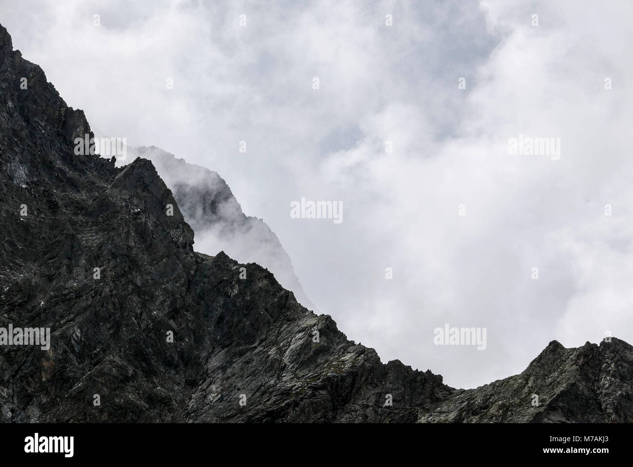 Nubes de luz detrás de la cresta rocosa, roca primaria, Tirol Foto de stock