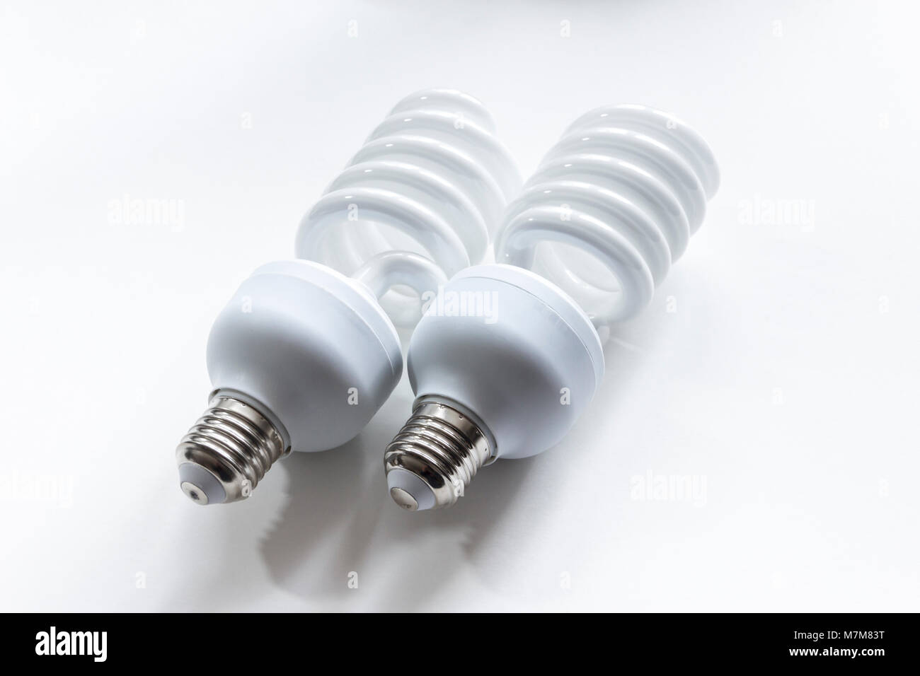 Dos eficientes fluorescentes de alta potencia bombillas fotográficas sobre un fondo blanco. Foto de stock