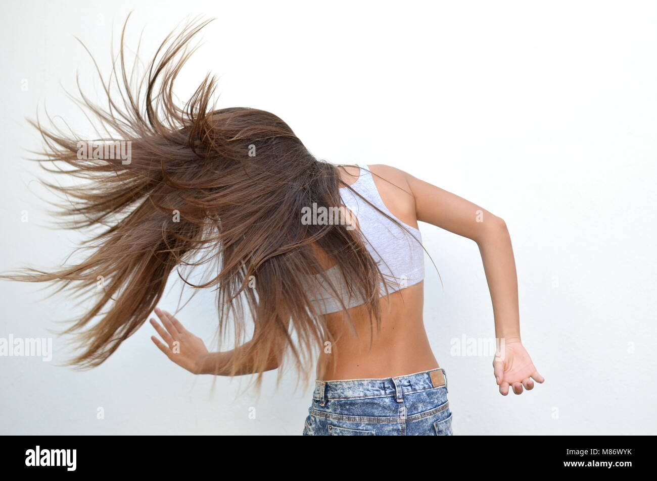 Adolescente bailando y sacudiendo su cabello Foto de stock