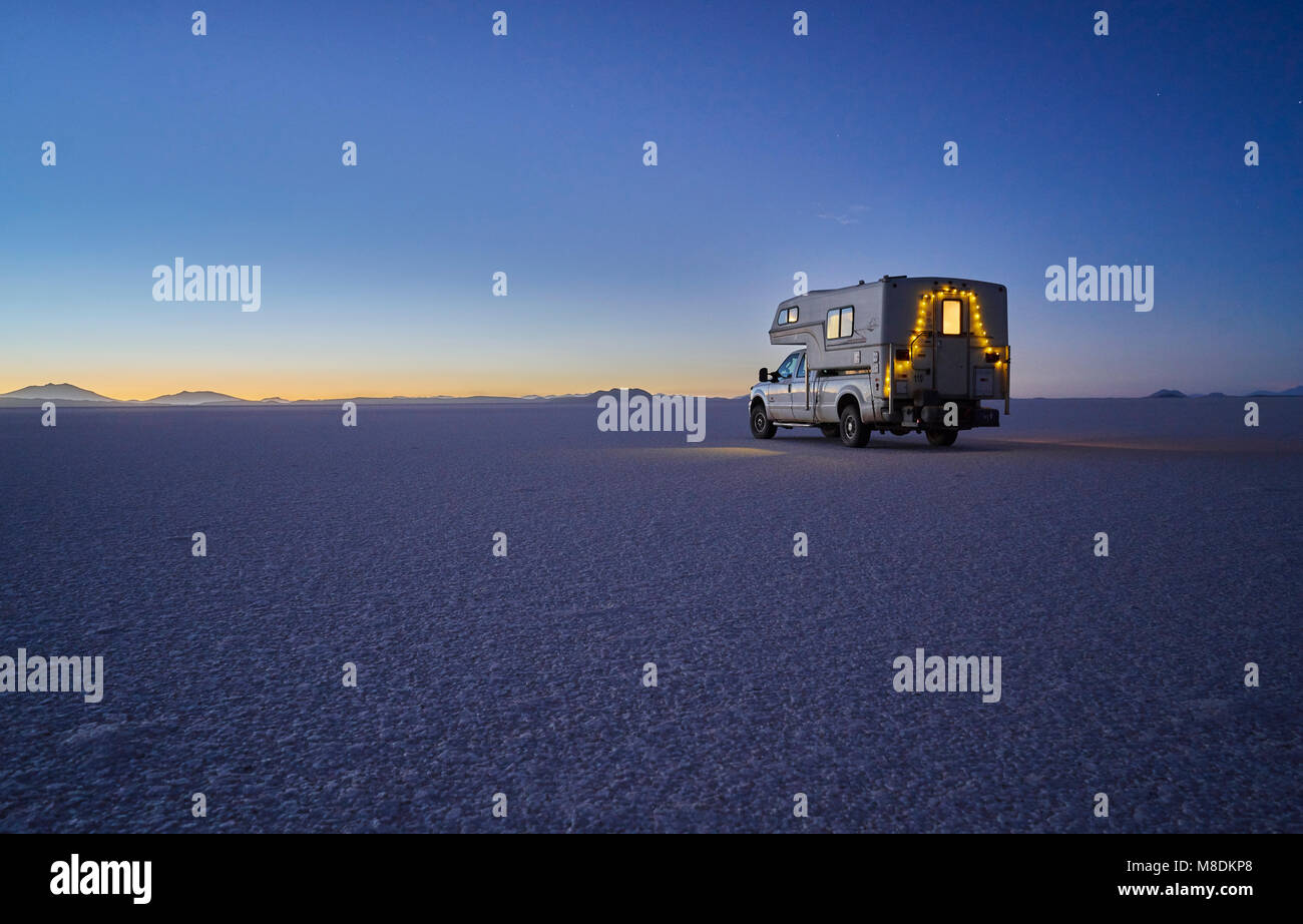 Vehículo recreativo, viajando al anochecer, a través de salinas, el Salar de Uyuni, Uyuni, Oruro, Bolivia, América del Sur Foto de stock