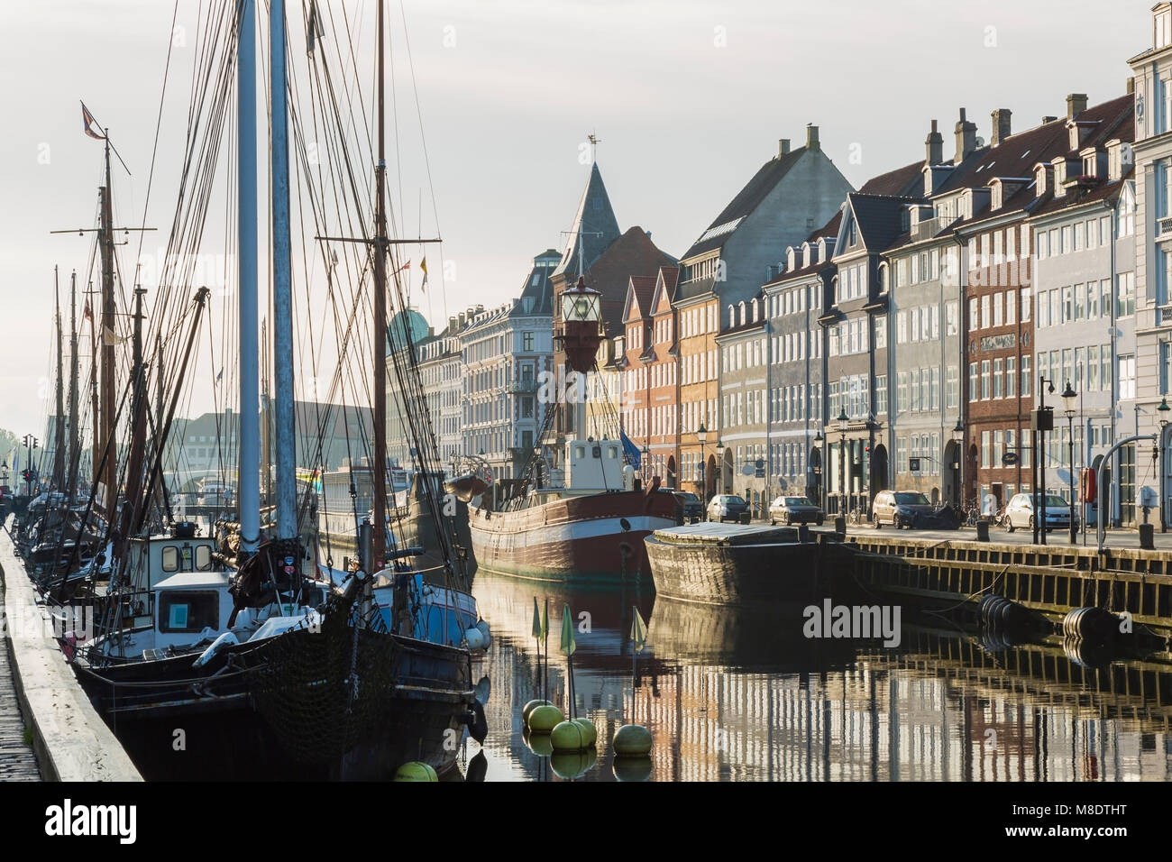 Amarrados los veleros y casas del siglo XVII en el canal de Nyhavn, Copenhague, Dinamarca Foto de stock