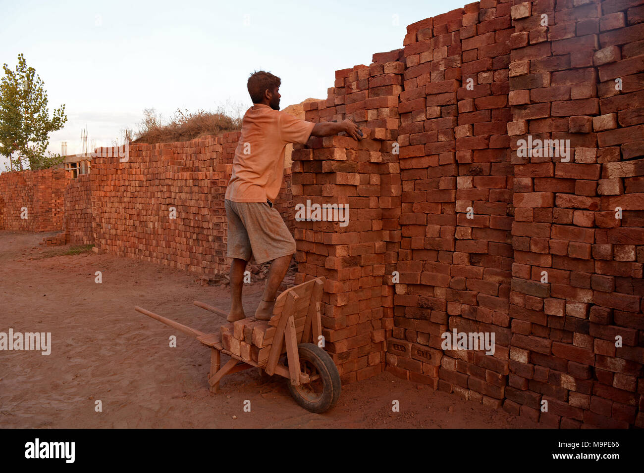 Un obrero Non-Kashmiri trabajando dentro de un horno de ladrillos en una aldea del distrito de Budgam central de Cachemira en la Cachemira administrada por India. Emisión de elementos tóxicos en una gran cantidad de hornos de ladrillos está causando graves amenazas para la salud pública y que tienen malos efectos sobre el medio ambiente. Estos hornos de ladrillos emiten humos tóxicos que son perjudiciales para los ojos, los pulmones y la garganta. Los humos procedentes de los hornos de ladrillos contienen materias particuladas suspendidas que son ricas en partículas de carbono y la alta concentración de monóxido de carbono y óxidos de azufre que provoca la contaminación del aire,y también stunt el físico y mental g Foto de stock