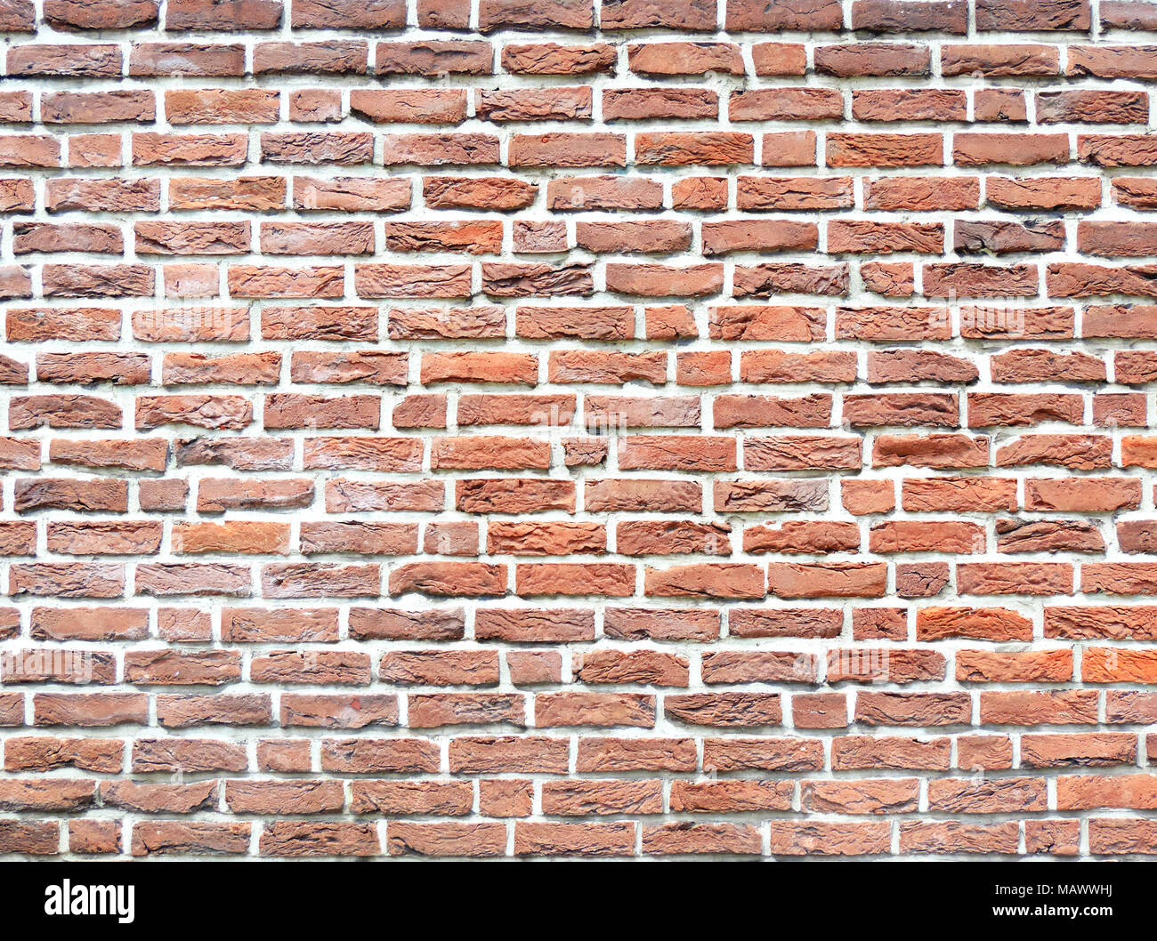 Muro de Piedra de ladrillo, con textura de fondo fondo de piedra. Disparo de fotograma completo de una pared de ladrillo rojo, como telón de fondo. Foto de stock