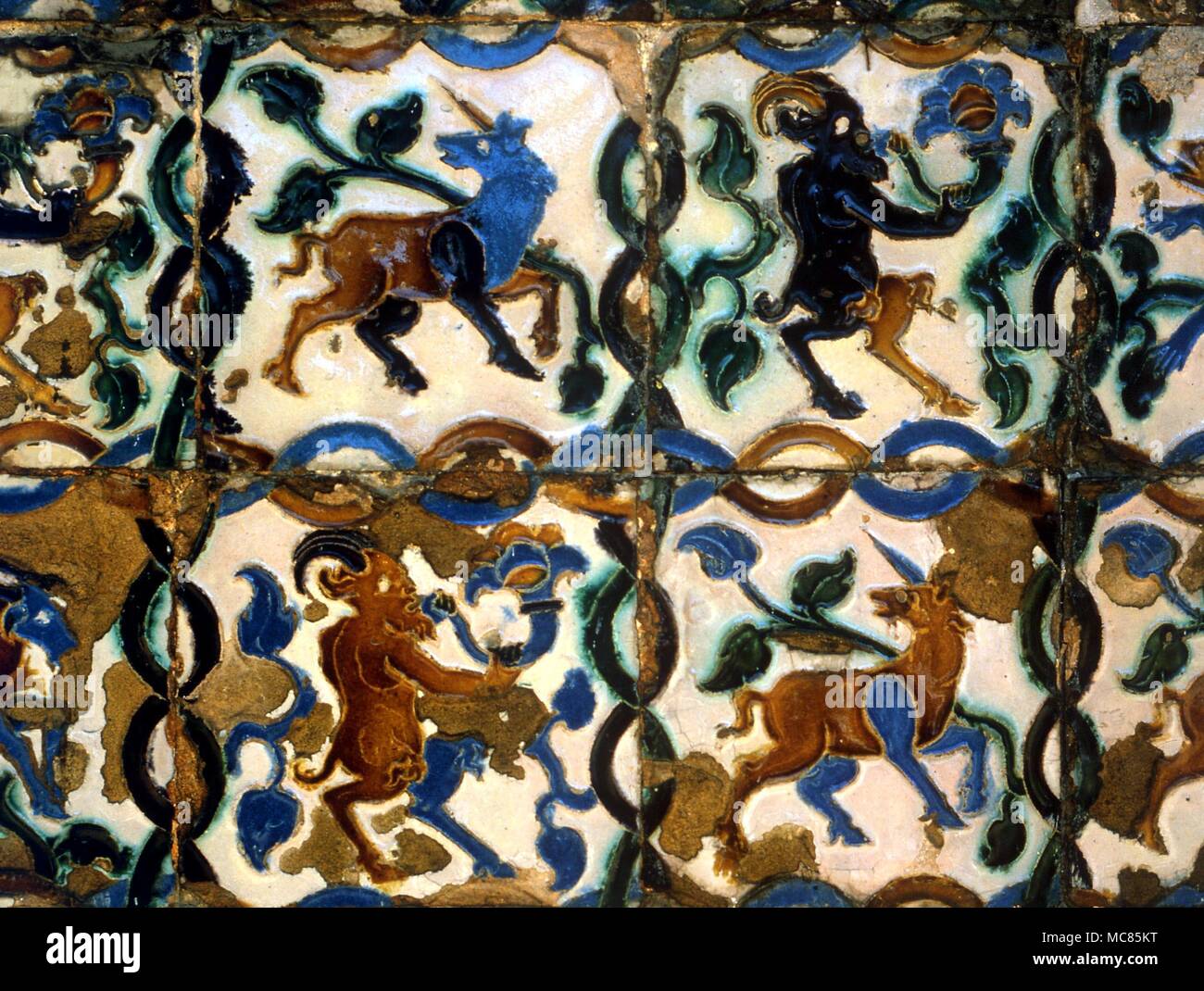 Dos figuras emblemáticas de unicornios, y dos sátiro-como las cabras. Azulejos en las paredes de los jardines del Alcázar, Sevilla, España. Foto de stock