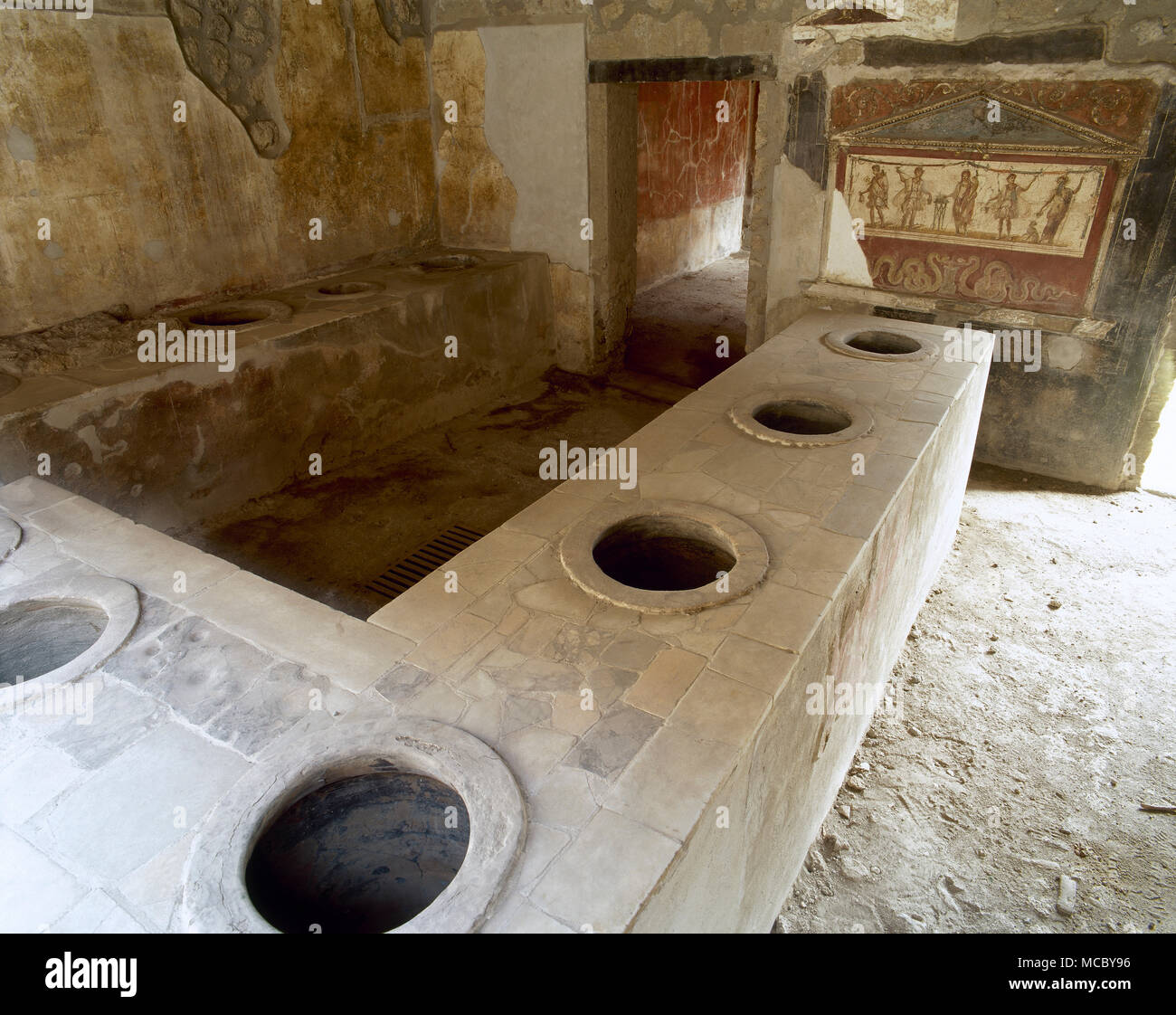 Pompeya. De Asellina Thermopolium. Barra de bar con agujeros para colocar las ánforas que contenían bebidas. La región de Campania, Italia. Foto de stock