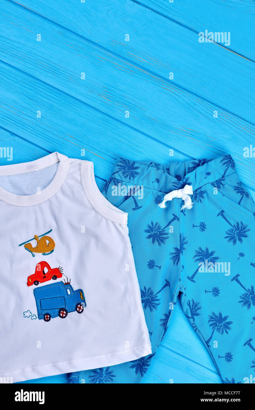 Hermoso juego de ropa para niño bebé. Impreso de verano los niños boy ropa  de moda, azul de fondo de madera Fotografía de stock - Alamy
