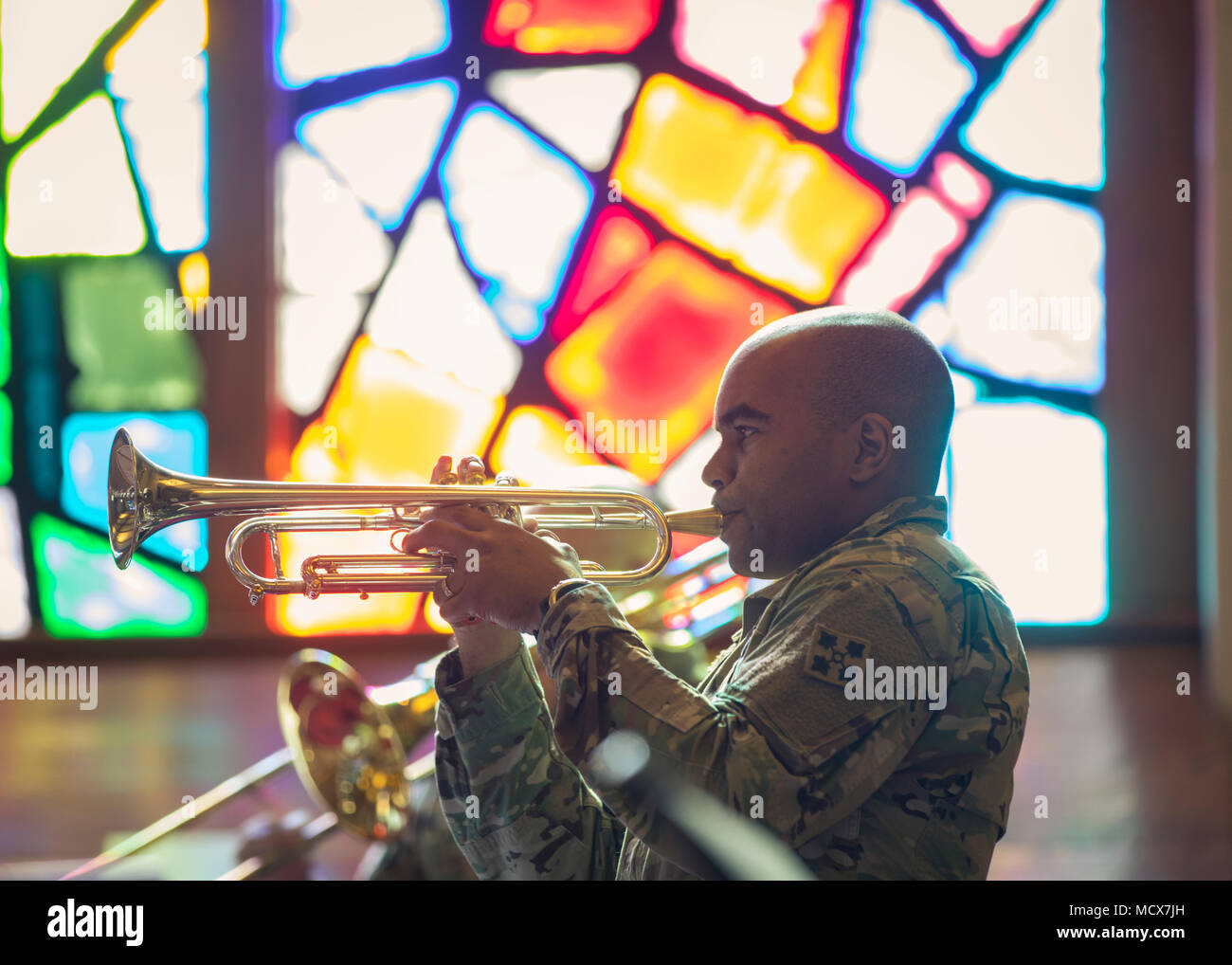 El Sgt. Primera Clase Christian Williams, instrumentista asignado a la 4ª  División de Infantería, la banda toca la trompeta durante una copia de  'Despertarme antes de ir' como parte de la banda