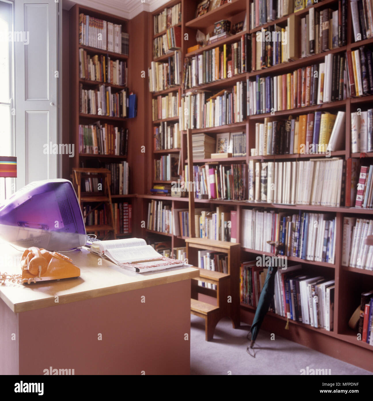 Una oficina en casa con estantes de libros y ordenador en el escritorio  Fotografía de stock - Alamy