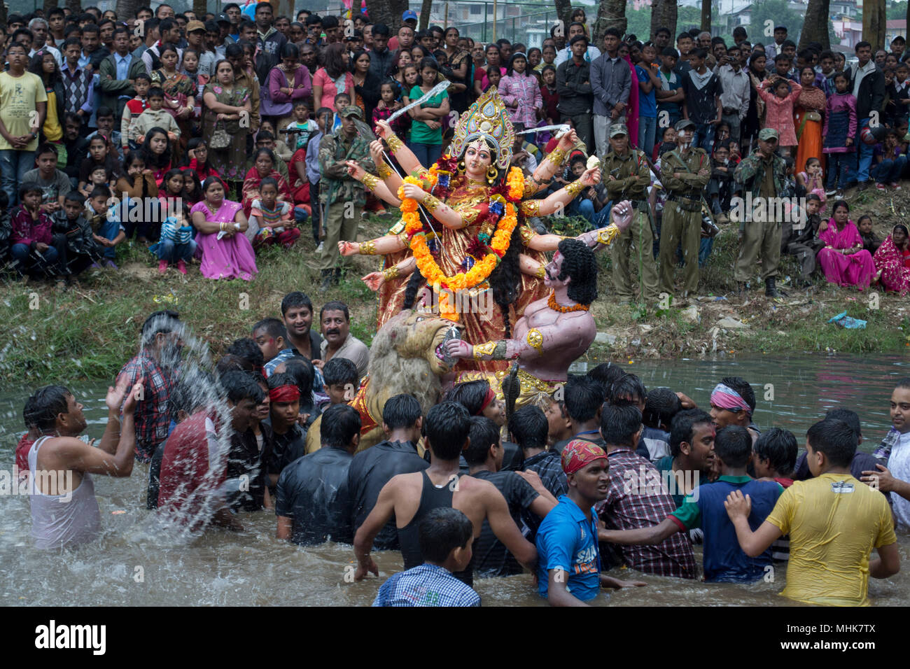 Shillong, al noreste de la India de 2012. Hombres indios acerca a sumergir el ídolo de la diosa hindú durante el festival Durga Puja Foto de stock