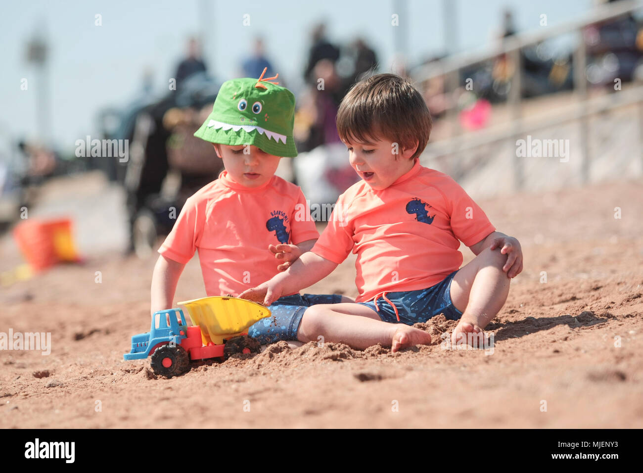 Dos y medio años de edad gemelos divertirse en Preston playa, Paignton, Devon. Foto de stock