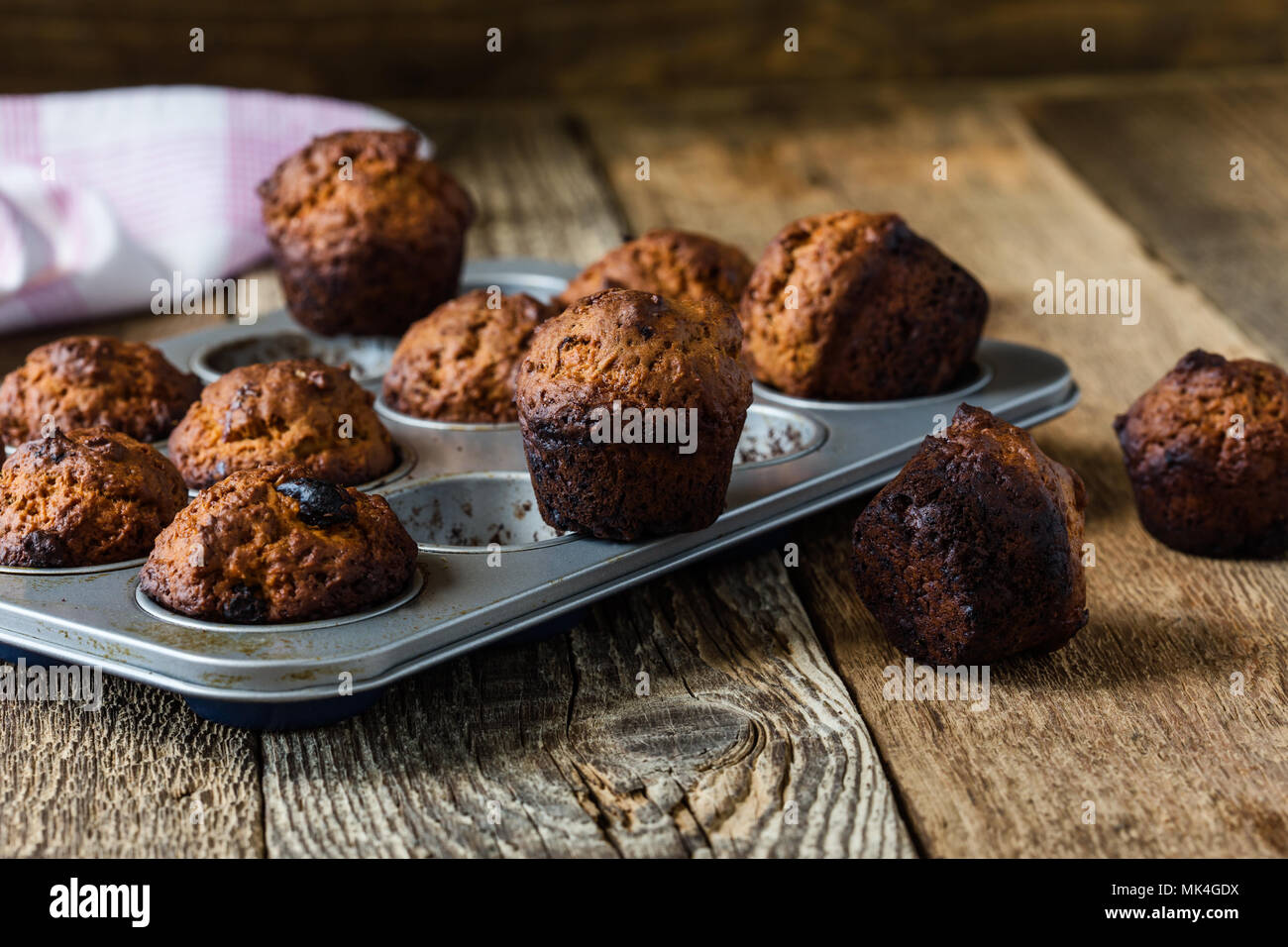 Muffins quemados en un molde para hornear sobre la mesa de madera ... Muffins quemados en un molde para hornear sobre la mesa de madera ...