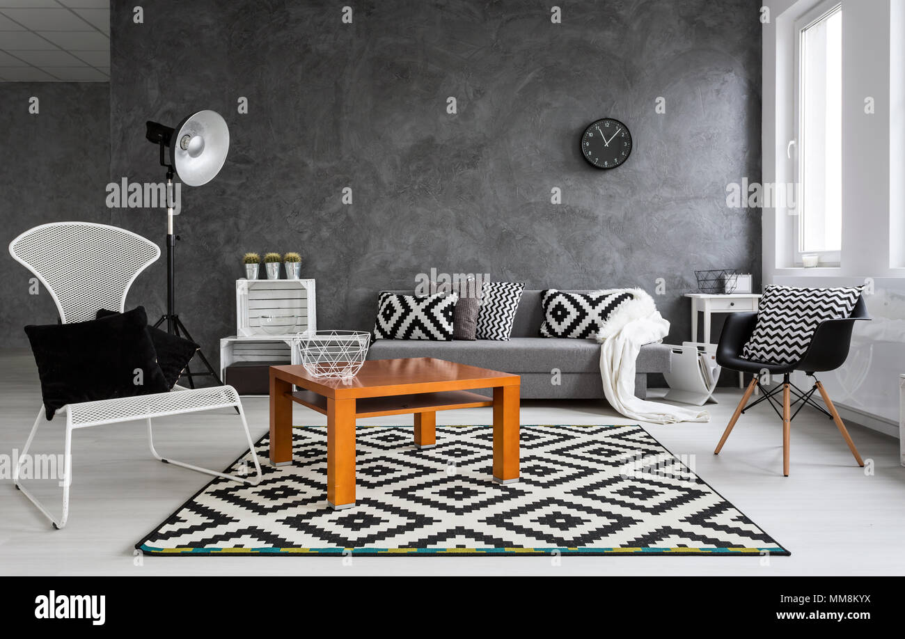 Gris sala de estar con sillas, una lámpara de pie, la pequeña tabla de madera y decoraciones de patrón en blanco y negro Fotografía de stock - Alamy