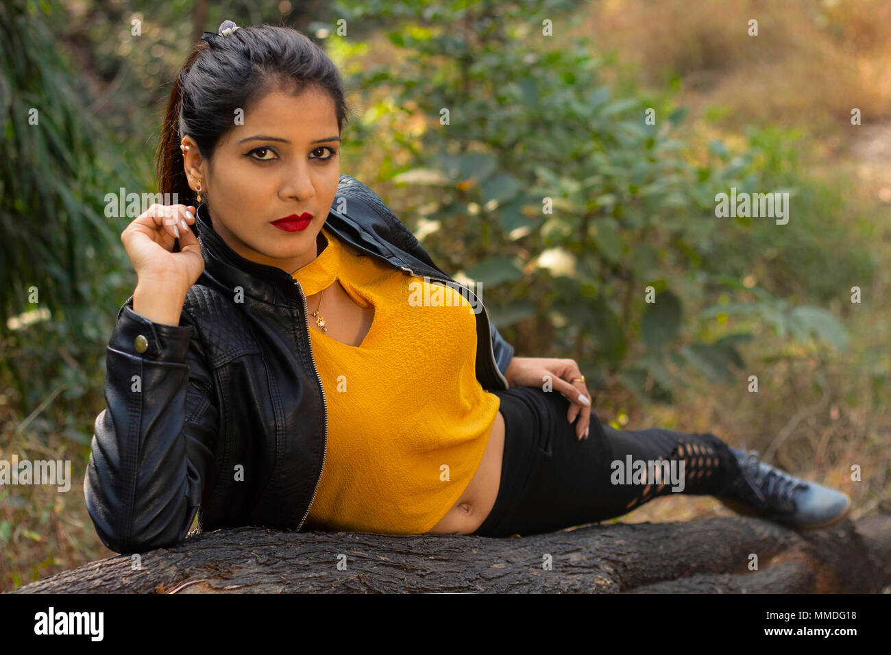 Mujer vistiendo elegante blusa amarilla, Chaqueta negra y pantalones  acostada mirando a la cámara Fotografía de stock - Alamy