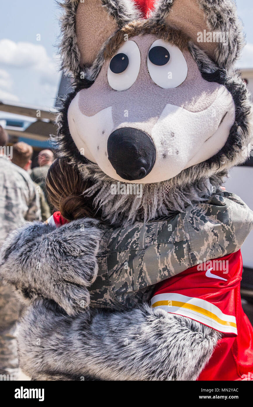 Un aviador estadounidense con la 139ª Ala de Transporte Aéreo, de la  Guardia Nacional Aérea de Missouri, se da un abrazo por KC Wolf, la mascota  de los Kansas City Chiefs, equipo
