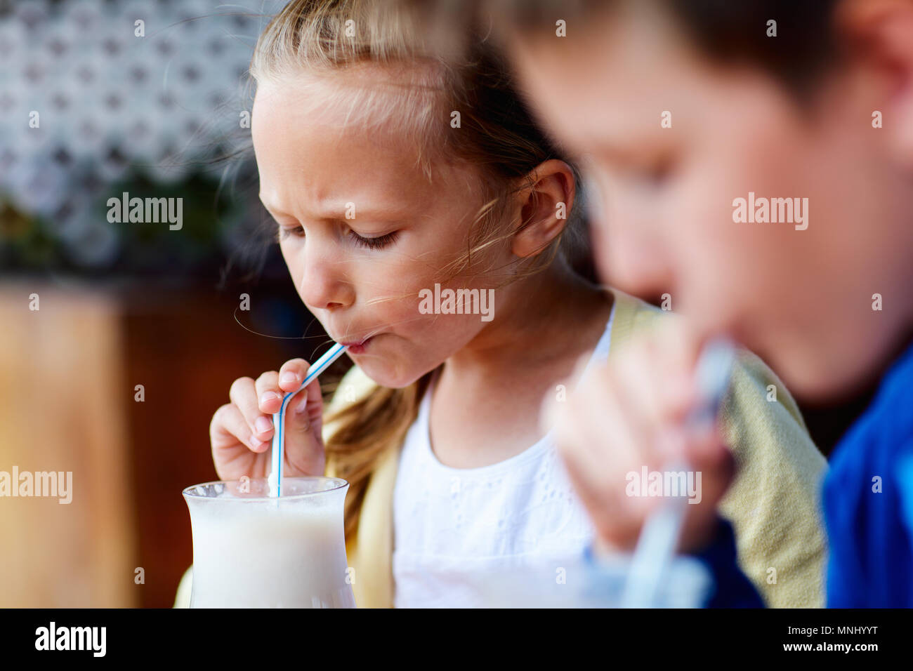 Los niños hermano y hermana de beber batidos en la cafetería al aire libre Foto de stock