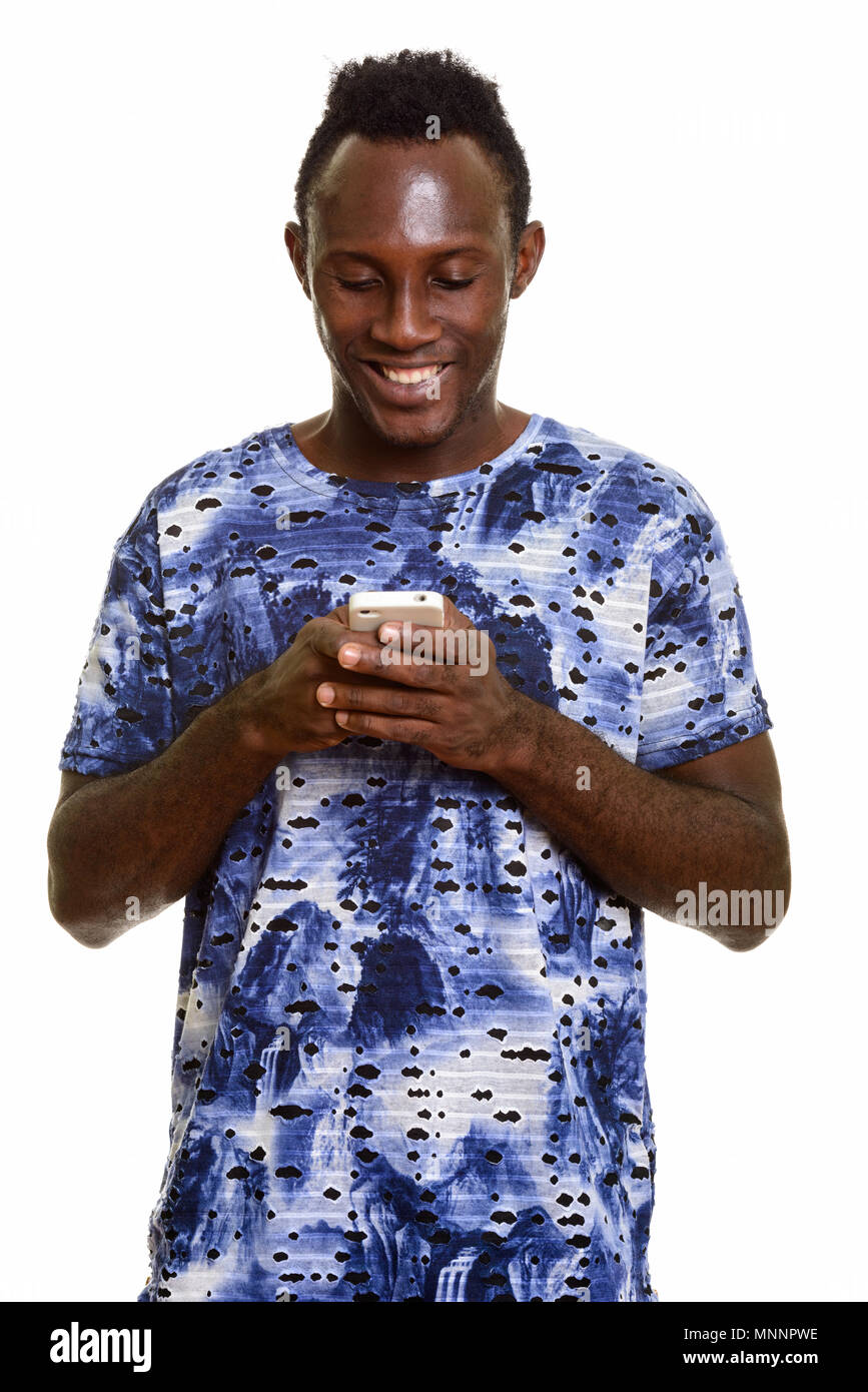 Los jóvenes africanos negros feliz hombre sonriendo mientras utiliza el teléfono móvil Foto de stock