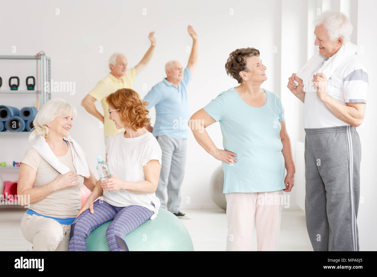 Anciano colocar personas llevando un estilo de vida saludable en un club de fitness Foto de stock
