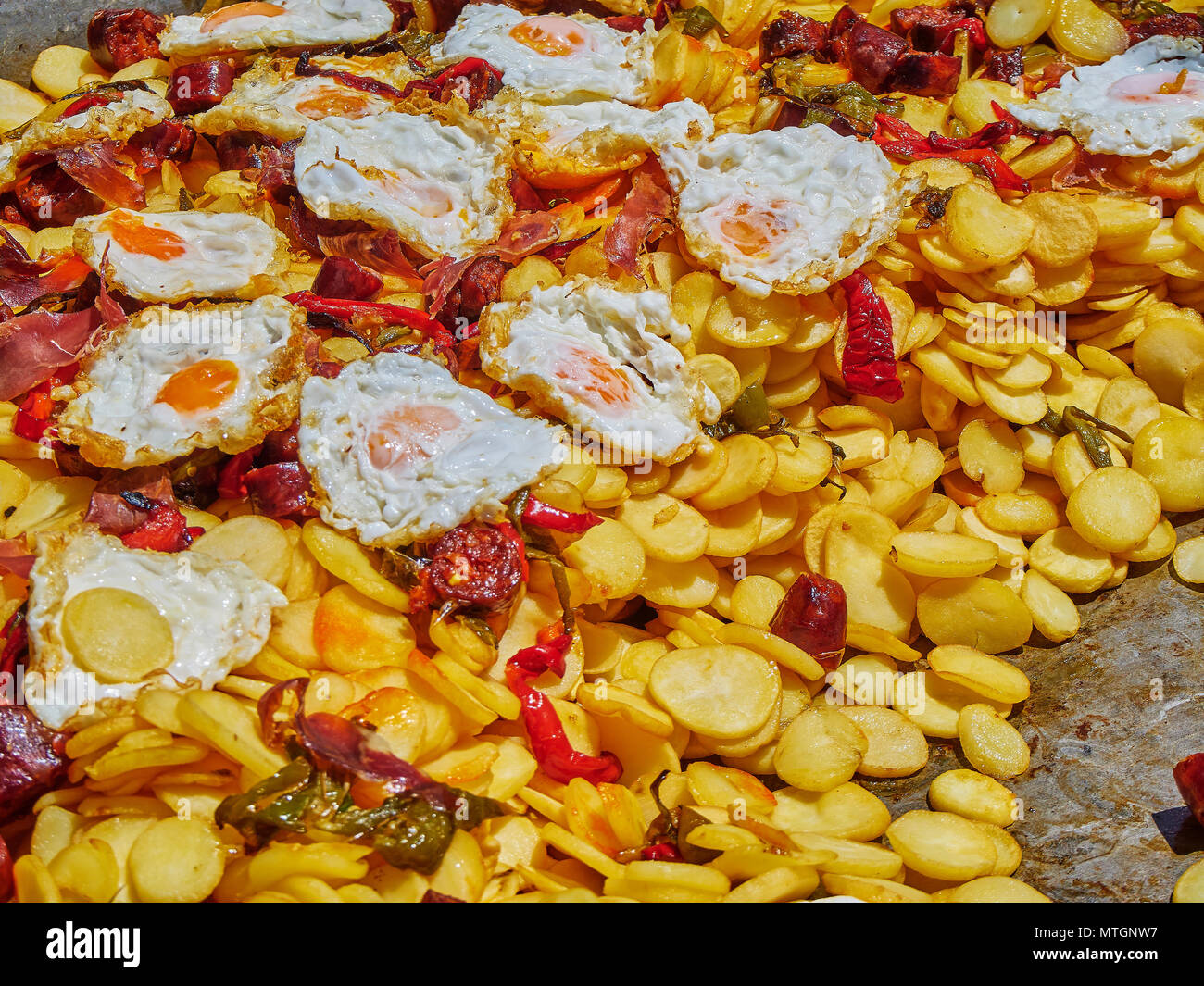 Español los huevos. Huevos fritos con chorizo, patatas y pimientos a la sartén. Español alimentos en la calle. Foto de stock