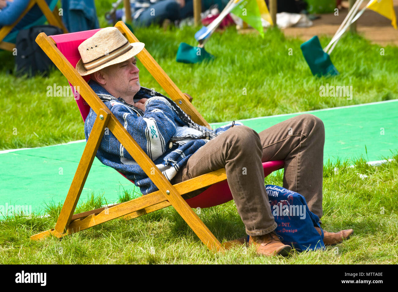 Hombre descansando en hamaca afuera, en el jardín en 2018 FESTIVAL DE HENO HENO-on-Wye Gales Powys UK Foto de stock