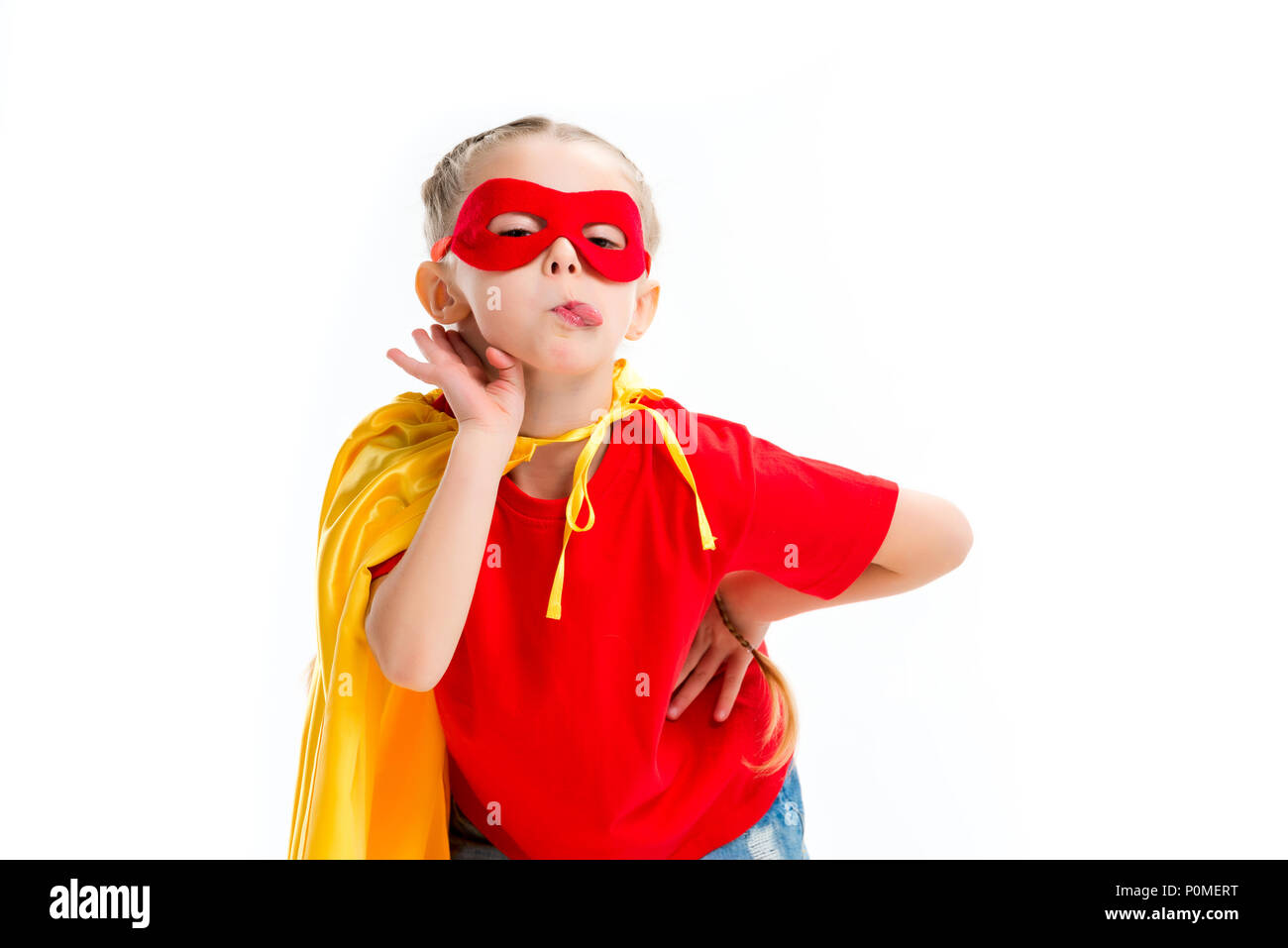 Supergirl llevar cabo amarillo y rojo máscara para ojos mostrando lengua  aislado en blanco Fotografía de stock - Alamy