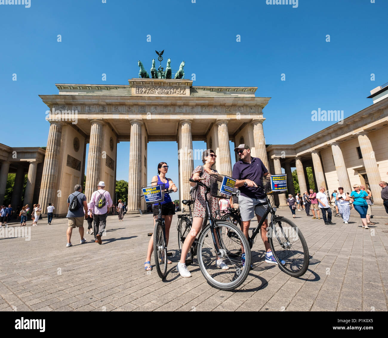 Los turistas de bicicletas delante de la Puerta de Brandenburgo en Berlín, Alemania Foto de stock