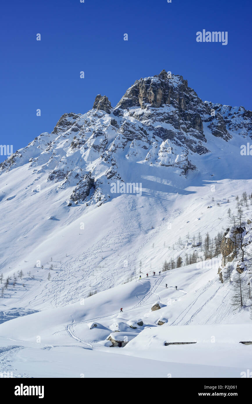 Varias personas back-esquí ascendente a Passo Croce, cobre en el fondo, el Passo Croce, Valle Maira, Cottian Alpes, P Foto de stock