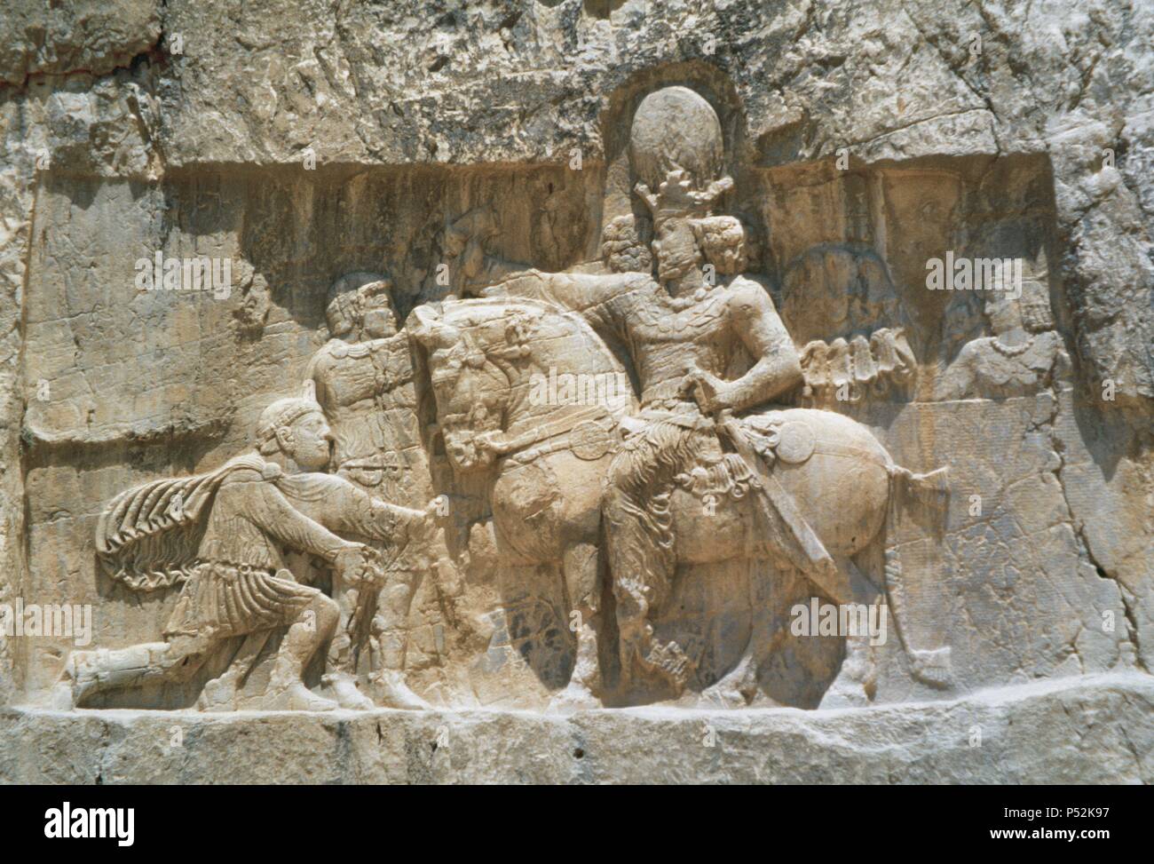 ARTE PERSA-PERIODO SASANIDA. Bajorrelieve del "TRIUNFO DE SEPUR I', donde se narra la rendición de los emperadores Valeriano y FILIPO 'el Arabe' tras las campañas de 252-261. A caballo el rey sasánida y arrodillado ante él, Valeriano, su prisionero hasta su muerte. Aliviar del s. III d. C. NAQSH-E ROSTAM (Naqsh-e Rustam). Provincia de Fars. República Islámica de Irán. Foto de stock