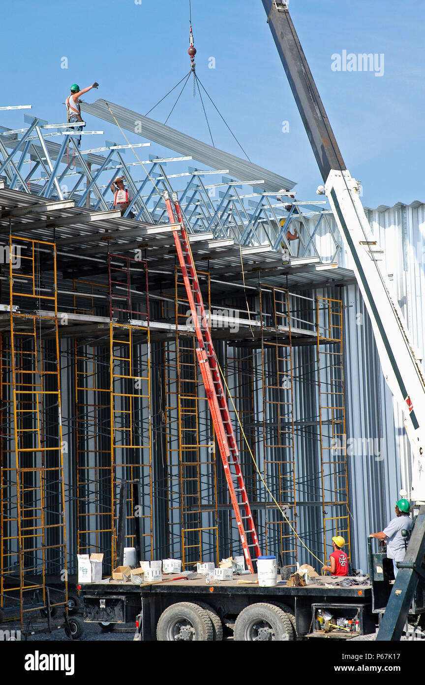 Los trabajadores de metal del techo, instalación de techos de metal, con grúa de construcción, instalaciones deportivas , Ottawa, Ontario, Canadá Foto de stock