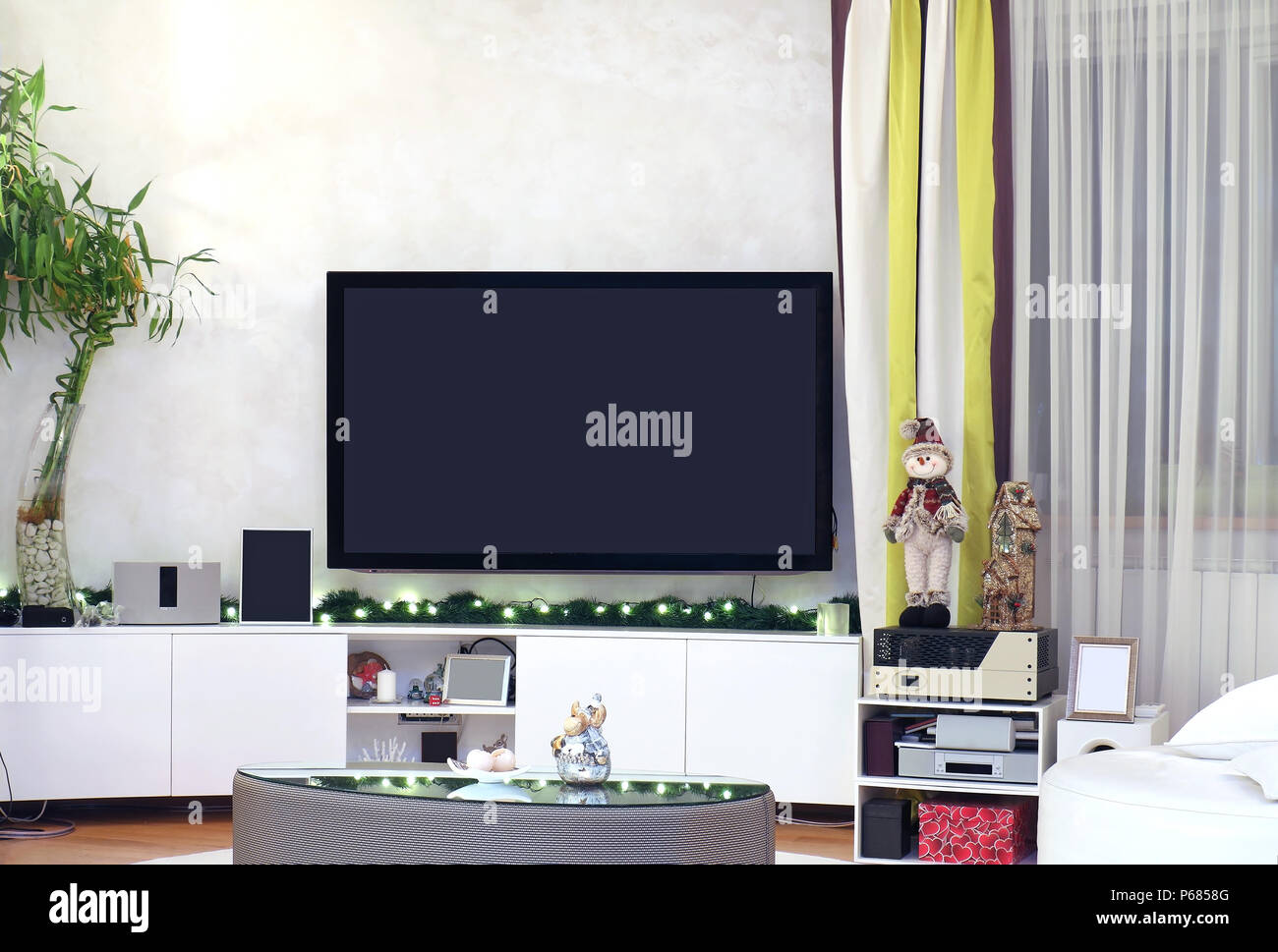Televisor grande interior moderno salón interior decorado con luces de  Navidad y adornos Fotografía de stock - Alamy