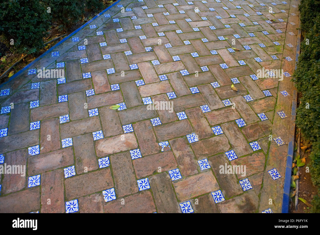 Hermoso sendero hecha de ladrillos y tejas, Jardín del Príncipe, los Reales Alcázares de Sevilla, Andalucía, España Foto de stock