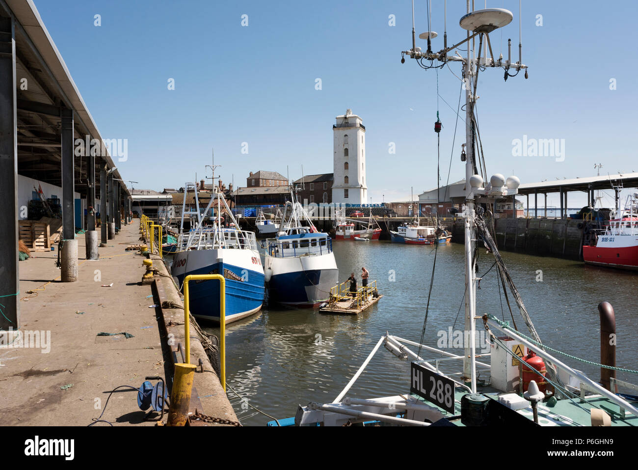 El muelle pesquero en North Shields, Tyneside, Inglaterra, con la luz baja en el fondo Foto de stock