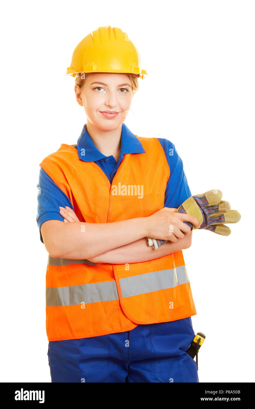 Mujer joven como trabajador de la construcción con casco y chaleco de seguridad y guantes protectores para seguridad Foto de stock
