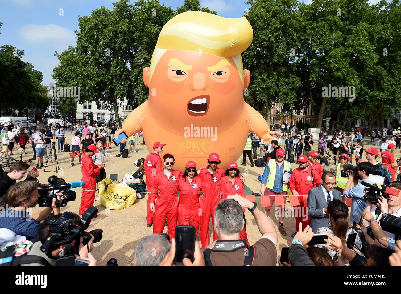Un globo de seis metros representando como Presidente estadounidense Donald Trump naranja revestido de pañales de bebé a través de la Plaza del Parlamento británico durante la visita del presidente. Crédito: Finnbarr Webster/Alamy Live News Foto de stock