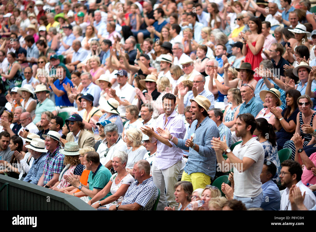 Los aficionados celebran después de que Kevin Anderson alcance su primera final de Wimbledon, venciendo a John Isner, de noveno año, estadounidense 7-6 (8/6) 6-7 (5/7) 6-7 9 en la semifinal más larga de la historia del torneo, el día once del Campeonato de Wimbledon en el All England Lawn Tennis and Croquet Club, Wimbledon. 11 6-4 26-24 Foto de stock