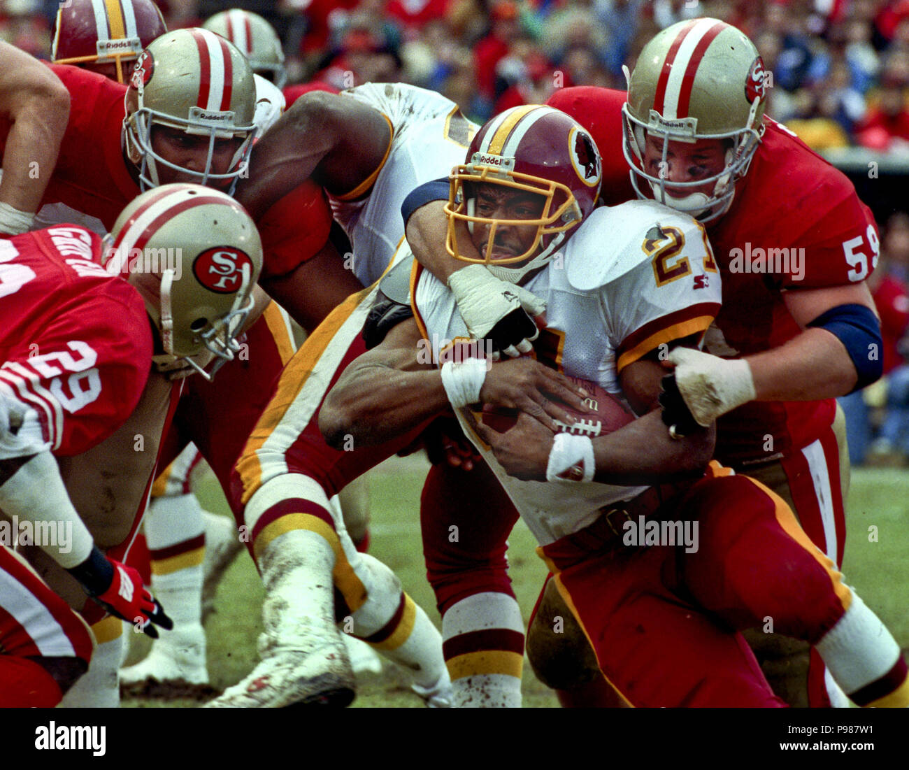 Atlanta Falcons linebacker Robert Lyles (54) pulls on the jersey of  Washington Redskins running back Earnest Byner (21) during first quarter  NFL Divisional playoff action, Jan. 4, 1992, at RFK Stadium in